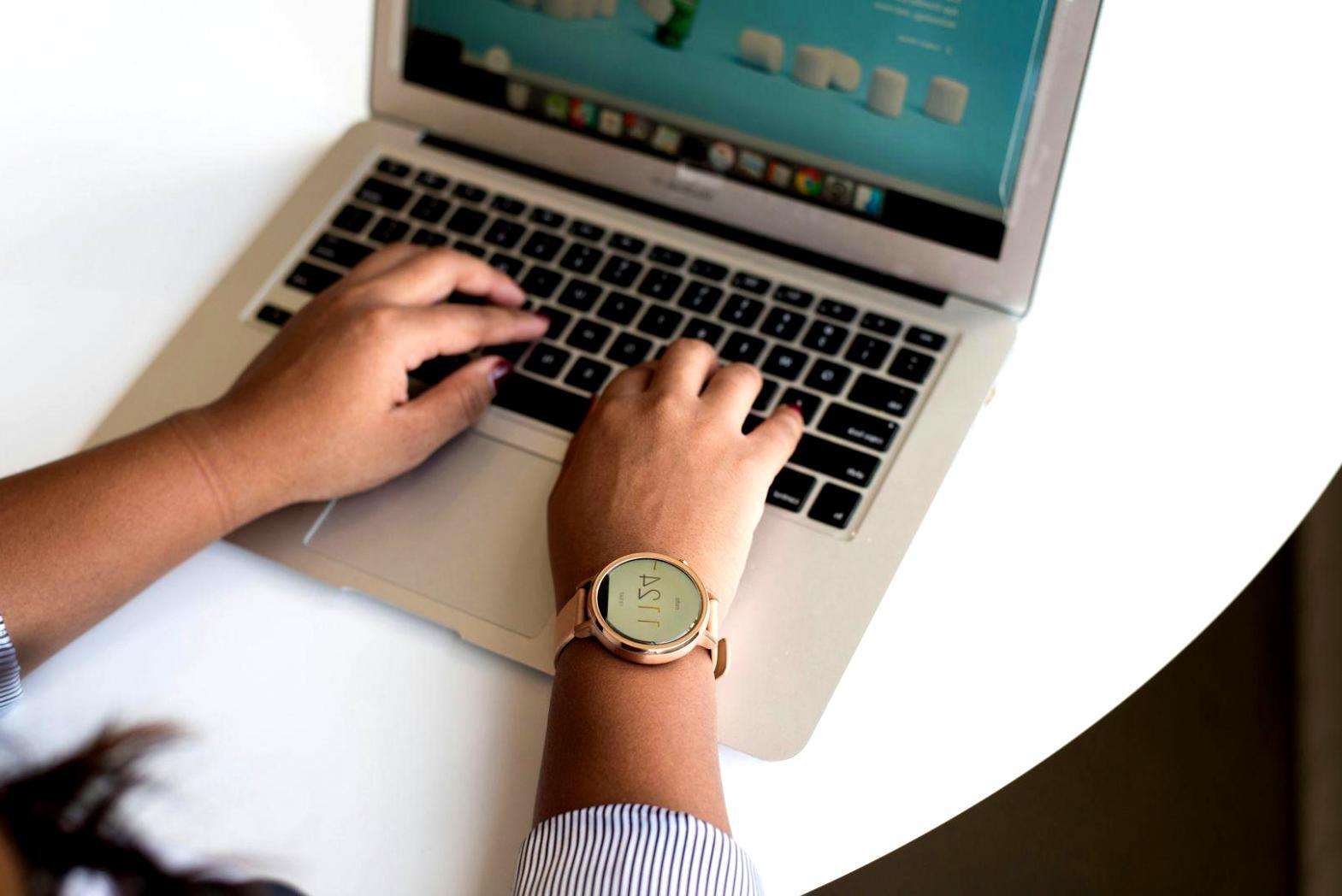 Professional business meeting with financial documents and laptops showing strategic planning session