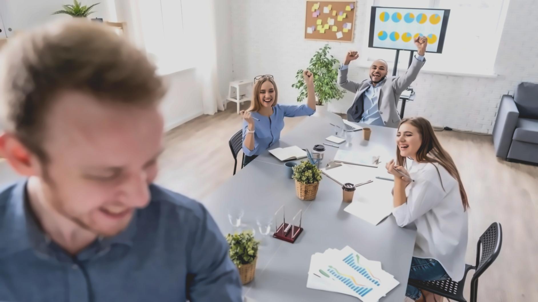 Financial analysis documents and charts spread across a desk with laptop showing market data